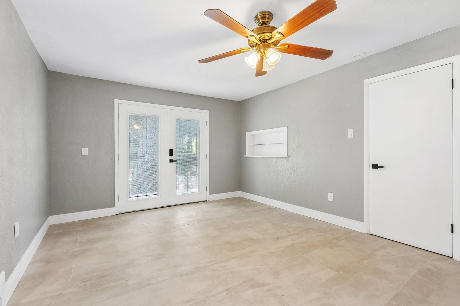 After: fresh gray paint, tile and French doors