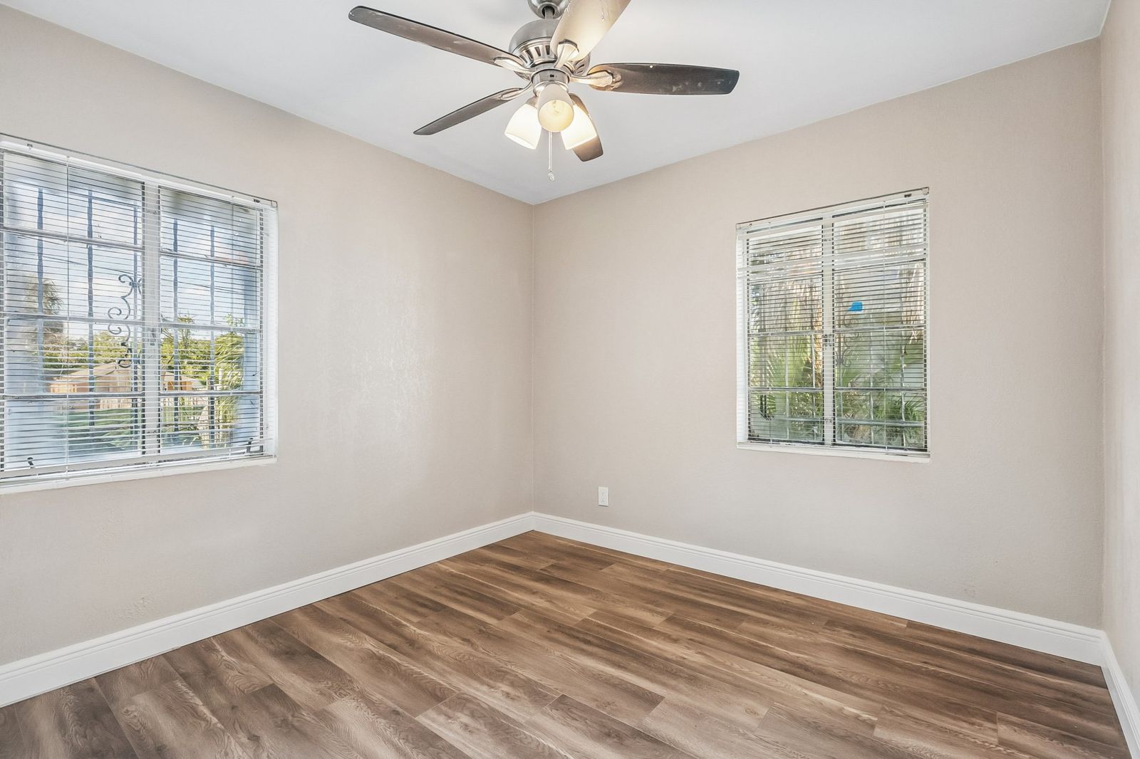 Bedroom with new gray wood-look vinyl plank flooring and fresh paint